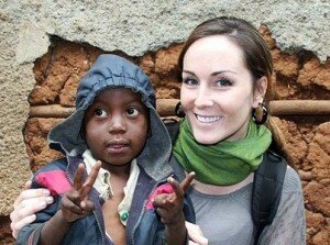 Canadian freelance journalist Amanda Lindhout sits with a child in Mogadishu, Somalia, in this undated handout photo. Lindhout, 27, and three others were abducted Aug. 23, 2008.