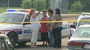 Witnesses speak to police about what happened early May 19 when a man was beaten near 70th Street and 149th Avenue. The young man later died in hospital. (CBC)