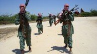 Militants of al Shabaab train with weapons on a street in the outskirts of Mogadishu