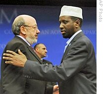 Somalia's Pres. Sheikh Sharif Sheikh Ahmed (R, EU Commissioner for Dev. and Humanitarian Aid, Louis Michel, chat in Brussels, 23 Apr 2009