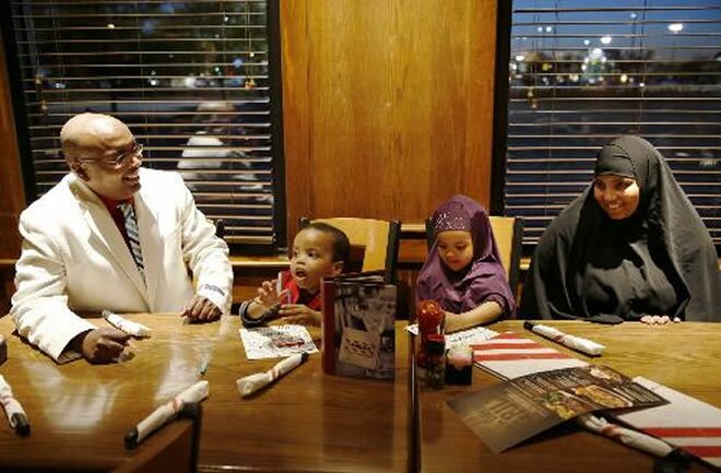 Ahmed Ali Said, a Somali-American running for the Ward 3 city council seat in St. Cloud, Minn. sits down to dinner with his family at TGI Fridays in St. Cloud on Wednesday, September 17, 2014. From left is Ahmed Ali Said, his son Suhayb Ali, 2, daughter... Photo: Leila Navidi