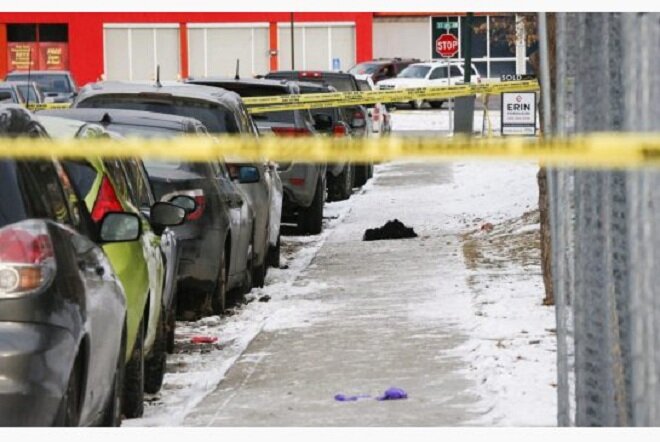 Discarded clothing lies on a sidewalk at the scene of a multiple shooting in Calgary on New Year's Day. Former Toronto resident Abdullahi Ahmed died in hospital from his wounds, while six others suffered various injuries. 